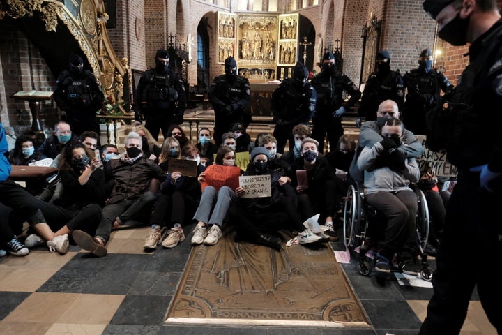 Demonstrators hold a protest against a ruling by Poland's Constitutional Tribunal that imposes a near-total ban on abortion, at a cathedral in Poznan, Poland October 25, 2020. 