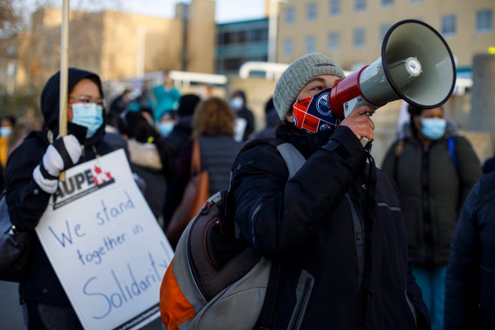 Royal Alexandra Hospital front-line workers walk a picket line after walking off the job in a wildcat strike in Edmonton on Oct. 26, 2020. 