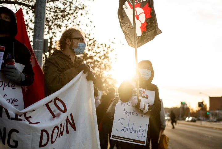 Royal Alexandra Hospital front-line workers walk a picket line after walking off the job in a wildcat strike in Edmonton on Oct. 26, 2020.