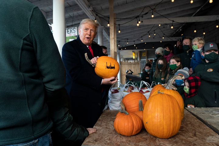 President Donald Trump signed a pumpkin during a visit to an orchard in Maine on Sunday.