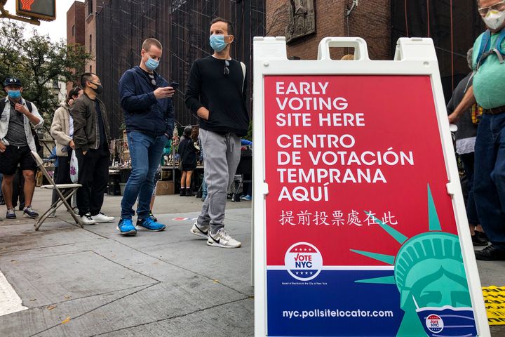 Voters wait in line for a Houston Street polling site on the first day of early voting, Saturday, Oct. 24, 2020, in New York. 