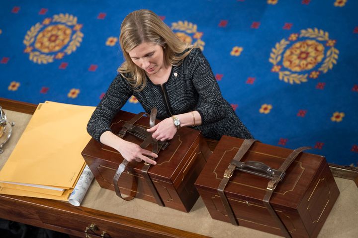 An aide opens Electoral College ballot boxes during a joint session of Congress to tally ballots for the president and vice president of the United States in January 2017.