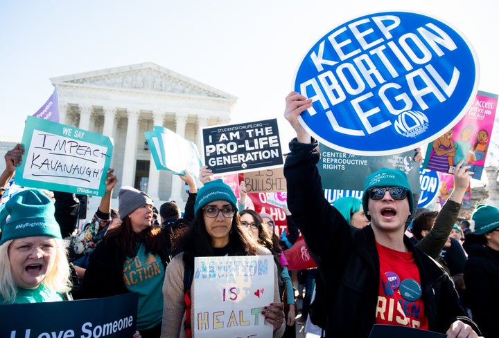 Pro-choice and anti-abortion activists clash outside the U.S. Supreme Court in March ahead of a hearing on another Louisiana abortion law.