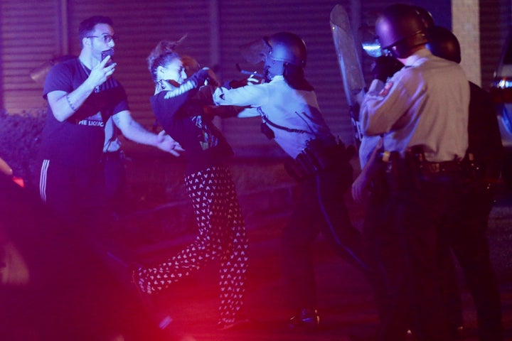 Police shove a woman who was arguing with them in West Philadelphia in the early hours of Tuesday, Oct. 27, 2020. Protesters gathered after police shot and killed Walter Wallace, a Black man having a mental health crisis on Monday.