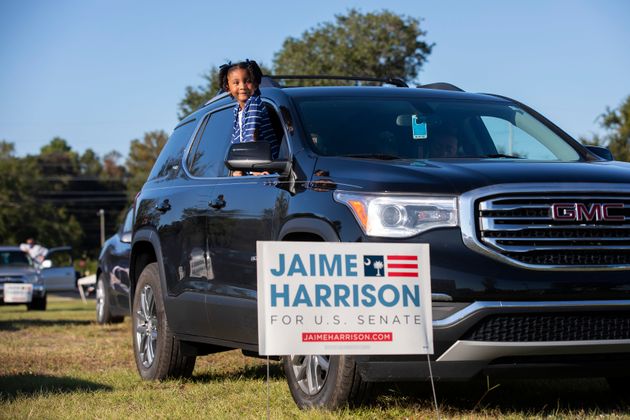 Braylen Washington waits for a drive-in campaign rally for Jaime Harrison to begin in North