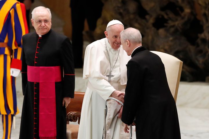 Pope Francis shakes hands with Monsignor Luis Maria Rodrigo Ewart as he arrives in the Paul VI Hall at the Vatican for his weekly general audience, Wednesday, Oct. 28, 2020. 