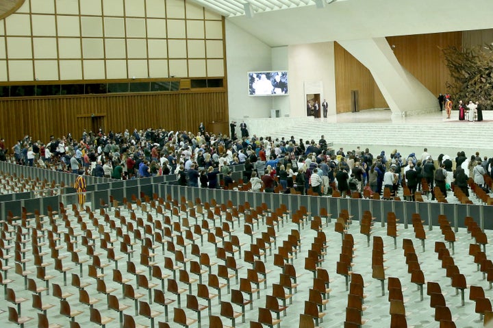 Pope Francis delivers his blessing to the faithful in a partially empty Paul VI Hall during his weekly general audience on October 28, 2020 in Vatican City, Vatican. 