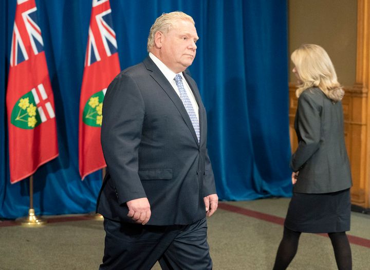 Ontario Premier Doug Ford passes Minister of Long-Term Care Merrilee Fullerton during the government's daily briefing at Queen's Park in Toronto on May 28, 2020.