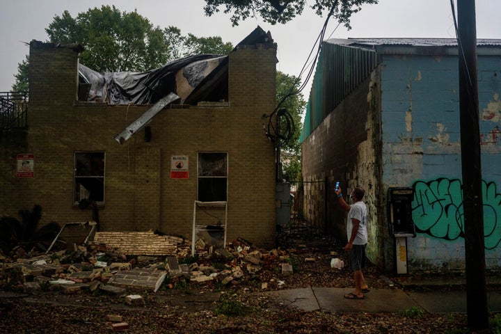 Joel Martinez, who until just recently lived in the lower apartment, takes a photo of Washington Garden's Apartments after it collapsed from the winds brought by Hurricane Zeta in New Orleans on Wednesday.