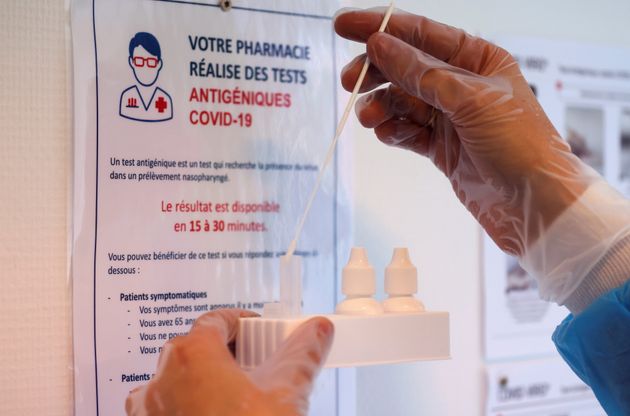A chemist performs a rapid Covid-19 antigenic test at a pharmacy in Roubaix as a second wave of the coronavirus...