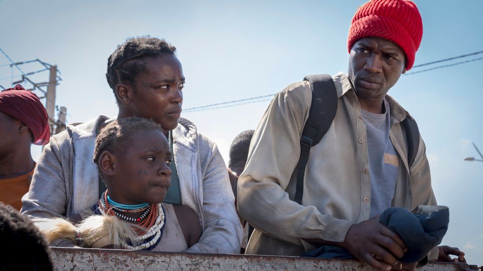 Establishing scenes show the couple fleeing south Sudan for Britain