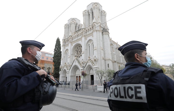 Police officers stand guard near Notre Dame church in Nice, southern France, on October 29, 2020.