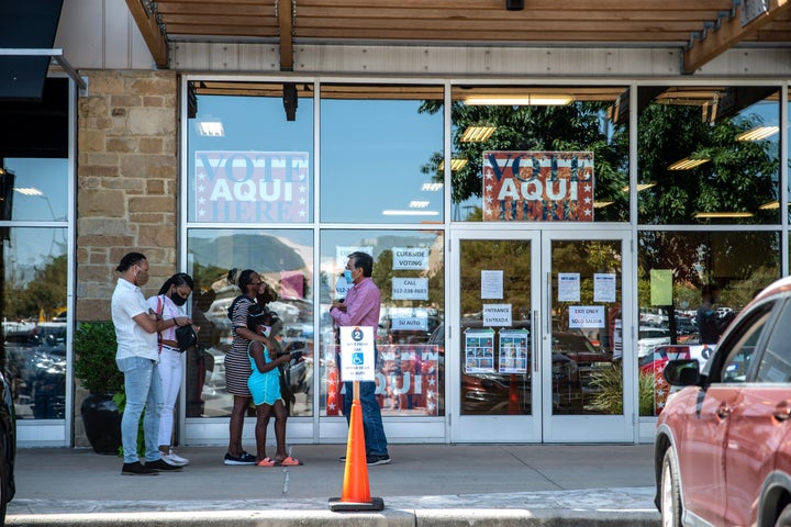 AUSTIN, TX - OCTOBER 13: Voters wait in line at a polling location on October 13, 2020 in Austin, Texas. The first day of voting saw voters waiting hours in line to cast their votes. Gov. Greg Abbott announced earlier this year that he would expand early voting for the election beginning on Oct. 13. Mail in voting began on Oct. 8 and has been part of a legal battle after Gov. Abbott declared each county may only have 1 mail in ballot drop off center, the ruling was later struck down in federal court but then the decision was upheld when a stay was ruled in the overturning. (Photo by Sergio Flores/Getty Images)