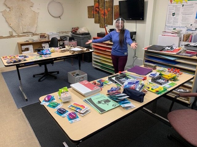 A teacher at Helen Kalvak School in Nunavut with school supplies donated from Facebook group "Help for Remote Northern Communities."