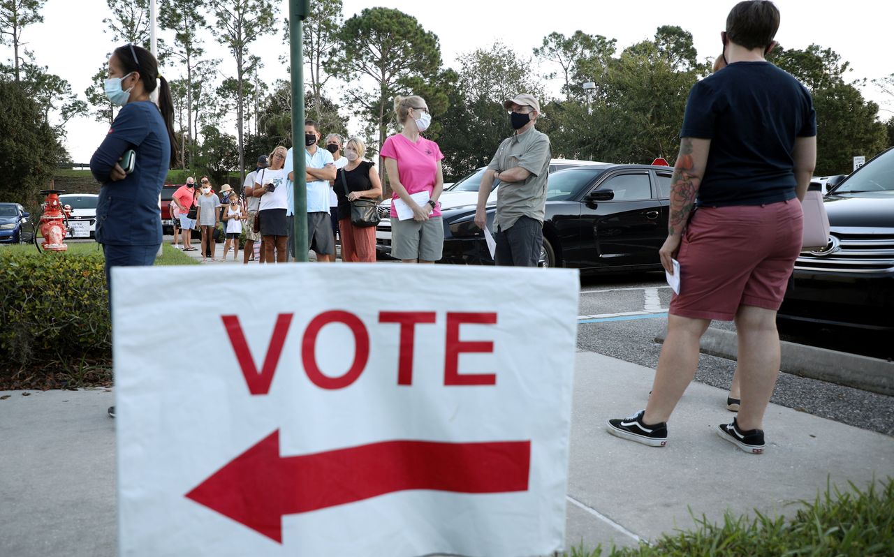 Voters line up to cast their ballots during early voting in Celebration, Florida, Oct. 25.