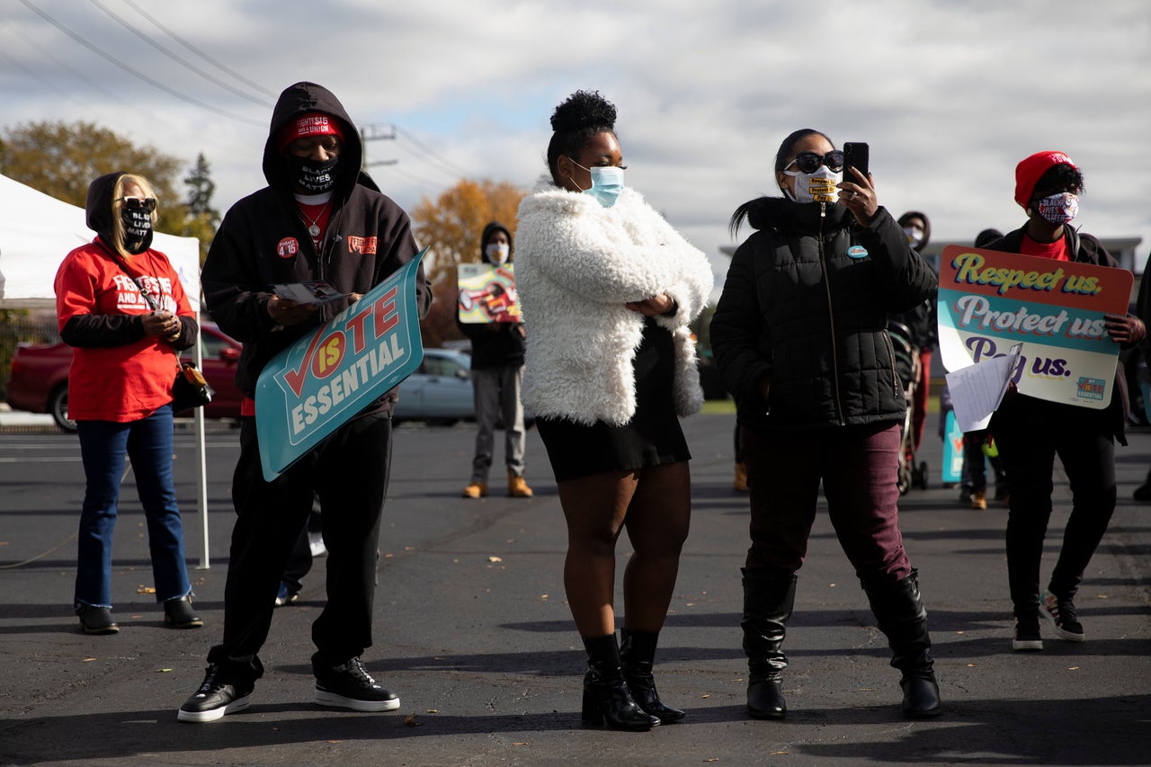 Fast-food and nursing home workers gather during a "My Vote is Essential" rally before casting their early ballots at Wayne County Community College in Detroit on Oct. 24.