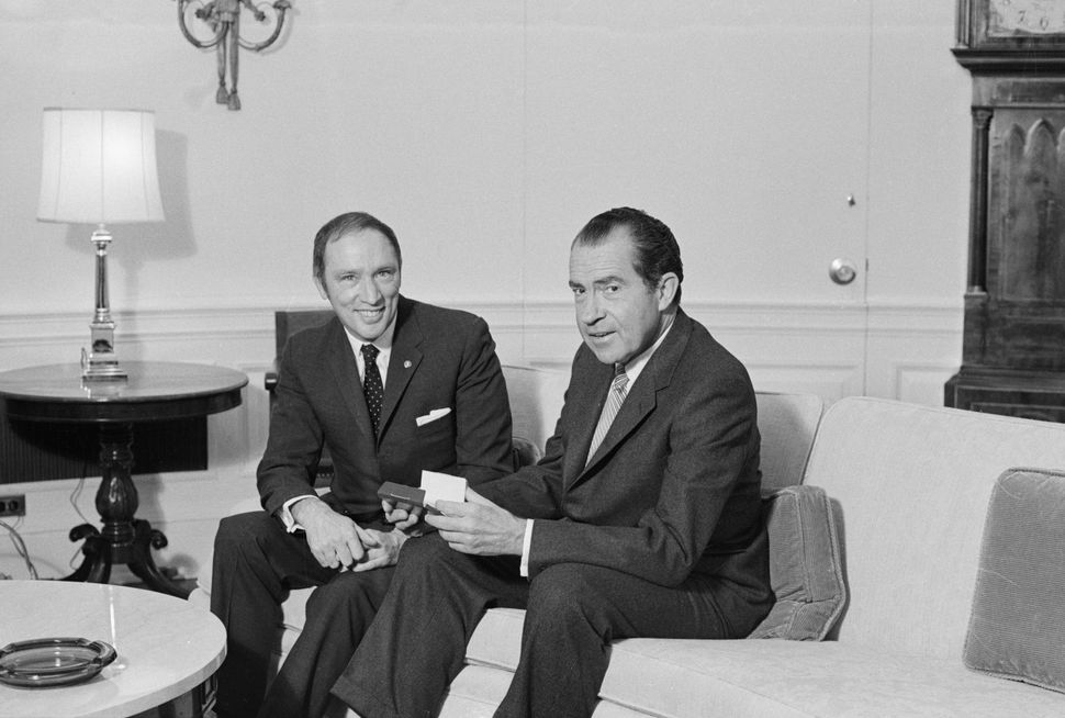 Archive photo of prime minister Pierre Trudeau and U.S. president Richard Nixon posing for picture on a sofa in the Chief Executive's office on March 24, 1969.