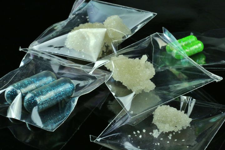 Individual bags of illegal drugs on a black background