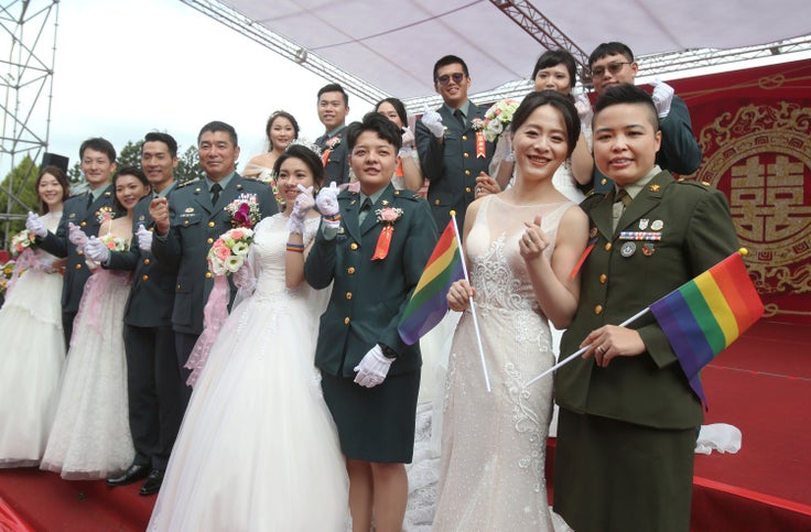The two lesbian couples tied the knot in a mass ceremony held by Taiwan's military on Friday in a historic step for the island. (AP Photo/Chiang Ying-ying)