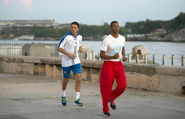 epa05000514 Italian Prime Minister Matteo Renzi (L) runs during his jogging activity, a moment of relaxation...