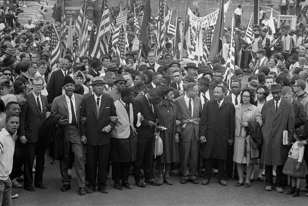 Dr. Martin Luther King leads an estimated 10,00 or more civil rights marchers out on the last leg of...