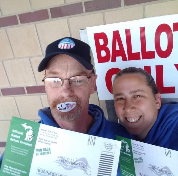 Ronald Hawthorne and his wife are pictured here voting early at a drop-off ballot box in Warren, Michigan.