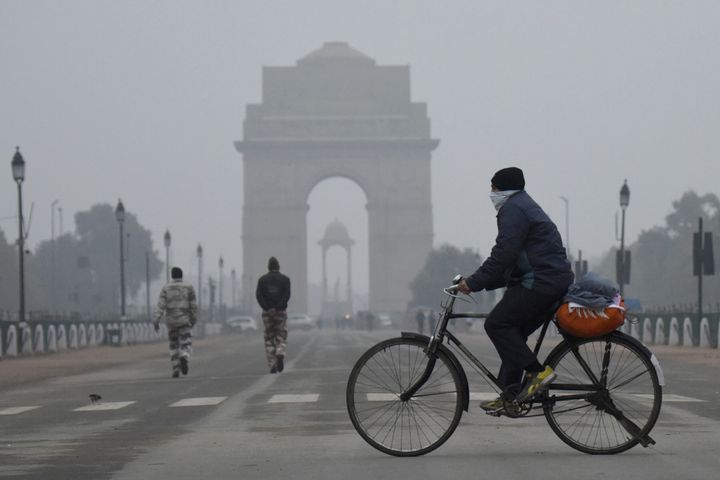 A cyclist on a cold winter morning with security personnel at India Gate in the backdrop can be seen in this file photo.