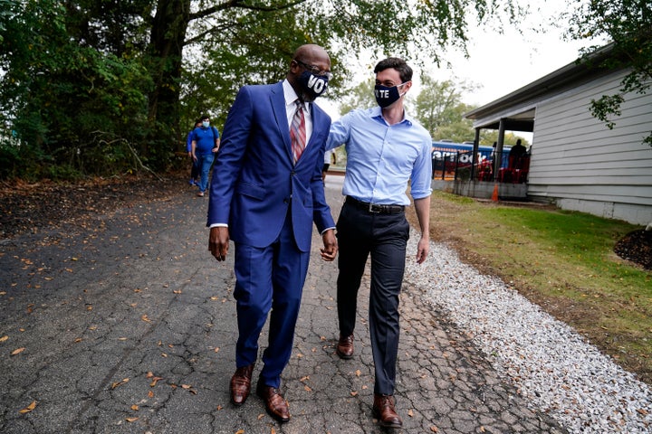 Democratic candidate for Senate Jon Ossoff, right, and Democratic candidate for Senate Raphael G Warnock, left, arrive before