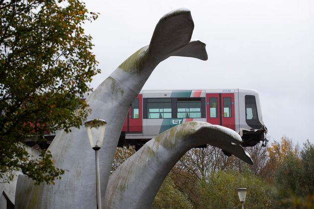 The whale's tail of a sculpture caught the front carriage of a metro train as it rammed through the end of an elevated section of rails 