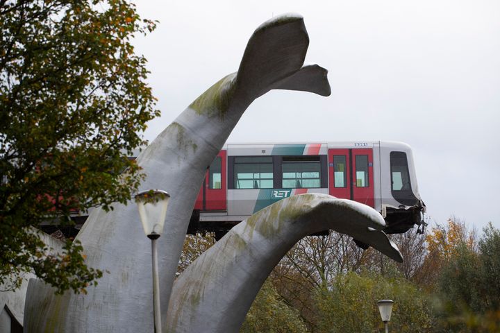The whale's tail of a sculpture caught the front carriage of a metro train as it rammed through the end of an elevated section of rails 