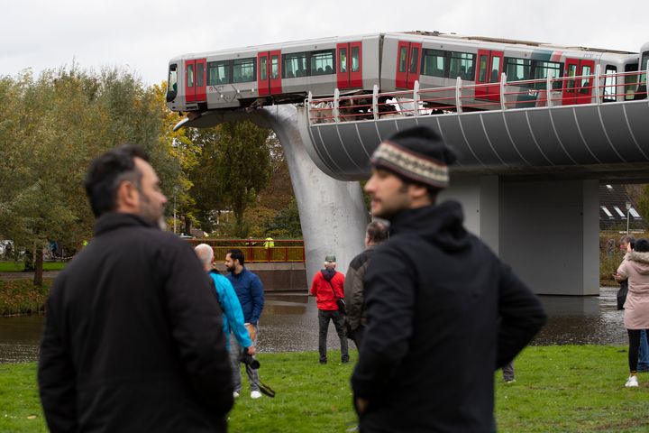 The whale's tail of a sculpture caught the front carriage of a metro train as it rammed through the end of an elevated section of rails with the driver escaping injuries in Spijkenisse, near Rotterdam, Netherlands