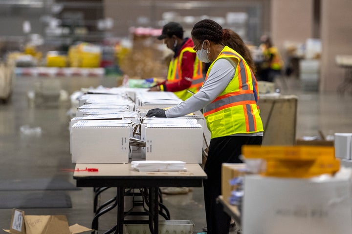 Workers are shown during a media tour highlighting the preparations for the sorting and counting of mail-in ballots at the Pe