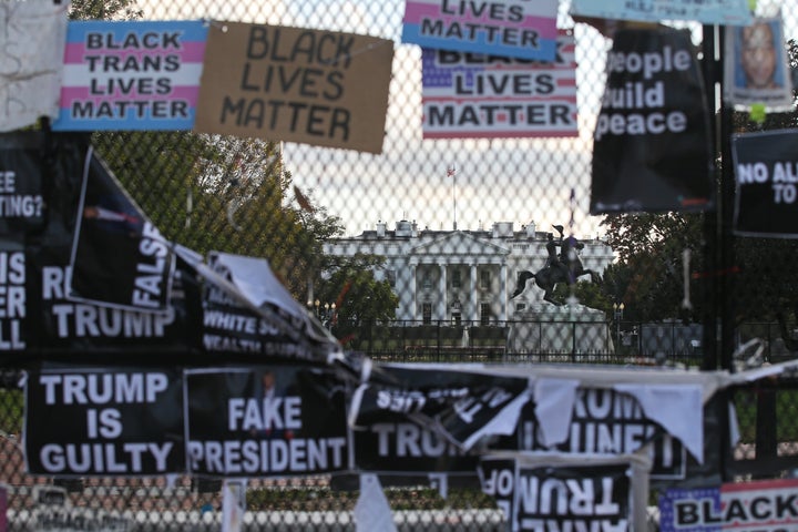 A White House fence covered with placards against Donald Trump's re-election is seen ahead of Tuesday's election.