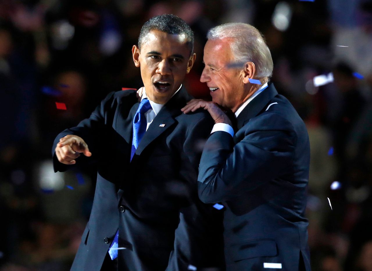 Obama gestures with Joe Biden after his election night victory speech in Chicago in 2012.