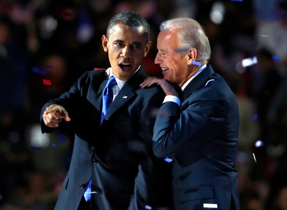 Obama gestures with Joe Biden after his election night victory speech in Chicago in 2012.