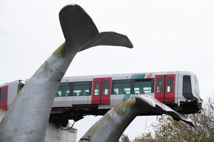 The whale's tail of a sculpture caught the front carriage of a metro train as it rammed through the end of an elevated sectio