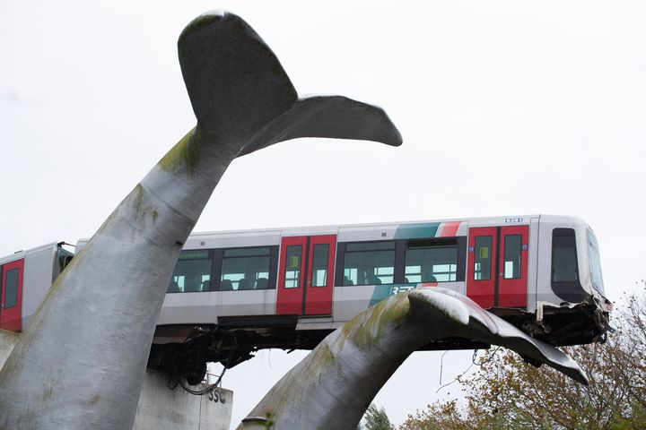 The whale's tail of a sculpture caught the front carriage of a metro train as it rammed through the end of an elevated section of rails with the driver escaping injuries in Spijkenisse, near Rotterdam, Netherlands, Monday, Nov. 2, 2020. (AP Photo/Peter Dejong)