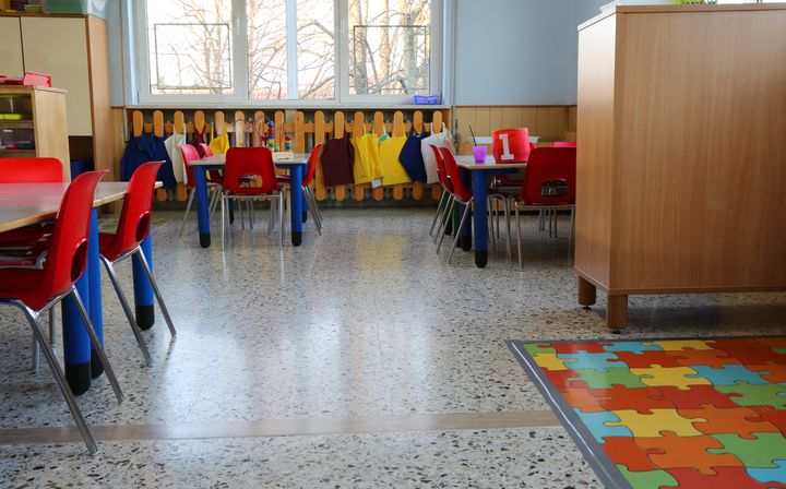 inside of a classroom in kindergarten with small chairs and tables