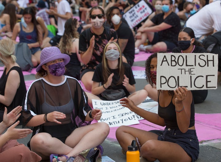 Hundreds of demonstrators congregate on College Street in front of Toronto Police Services HQ on June 19, 2020.<br>