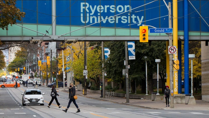 Students walk below a Ryerson University sign in Toronto, Canada, on Oct. 20, 2020.