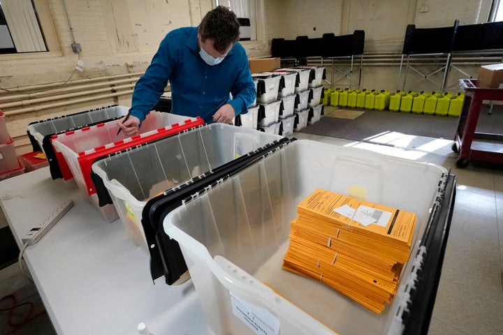 Assistant City Clerk James Blatchford prepares absentee and early vote ballots at Haverhill City Hall to be sent to precincts for Election Day counting, Monday, Nov. 2, 2020, in Haverhill, Massachusetts. 