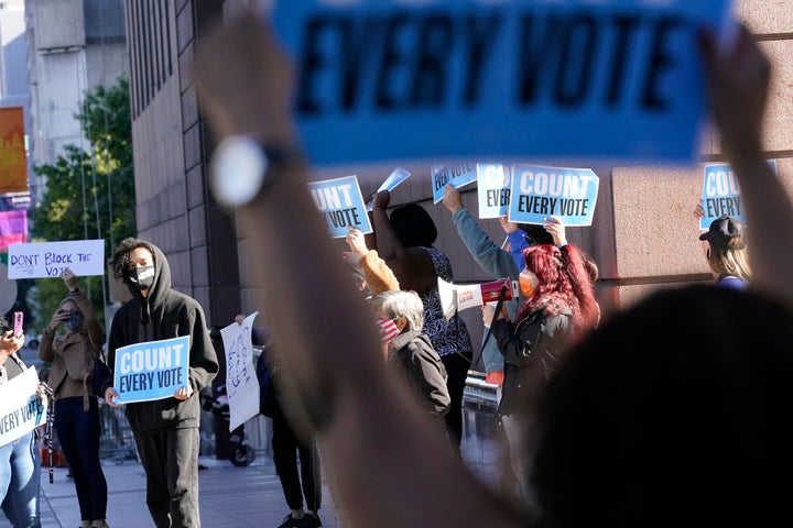 Demonstrators stand across the street from the federal courthouse in Houston, Monday, November 2, 2020,