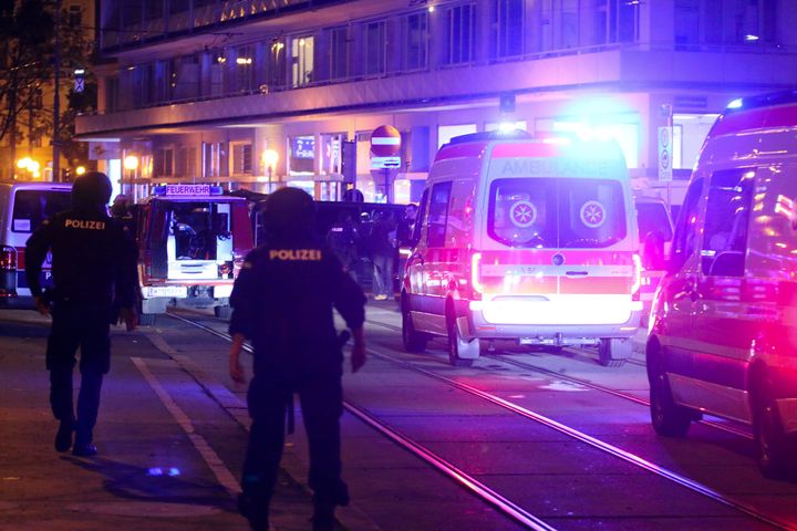 A police officers walk near ambulances at the scene after gunshots were heard, in Vienna, Monday, Nov. 2, 2020. 