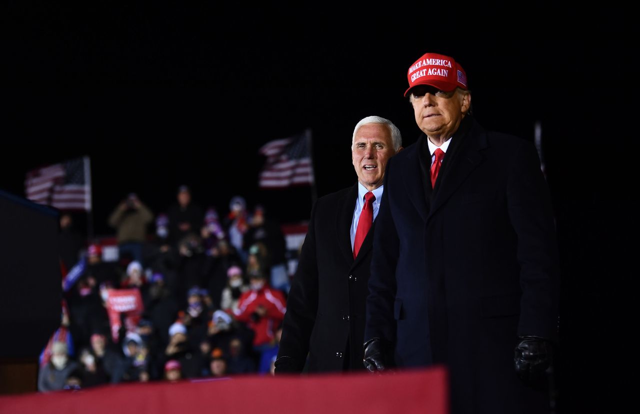 US President Donald Trump stands on stage with Vice President Mike Pence at the conclusion of his final Make America Great Again rally of the 2020 US Presidential campaign at Gerald R. Ford International Airport November 3.