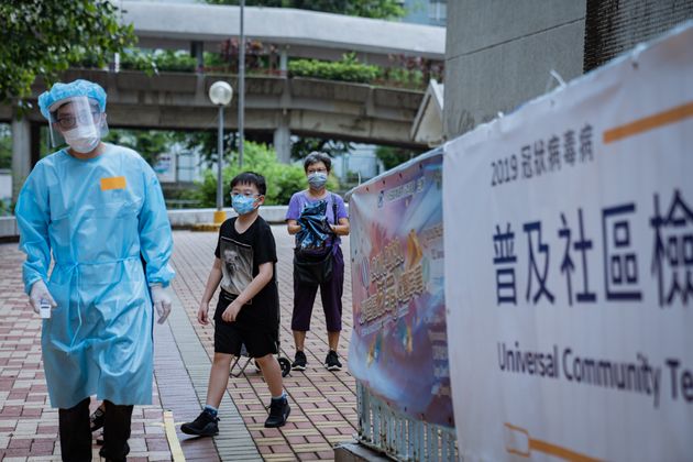 Medical staff dressed in a protective suit during the voluntary mass-testing programme for coronavirus. 