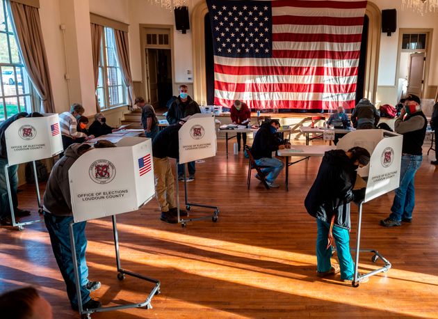 Voters cast their ballots at the old Stone School, used as a polling station, on election day in Hillsboro, Virginia.