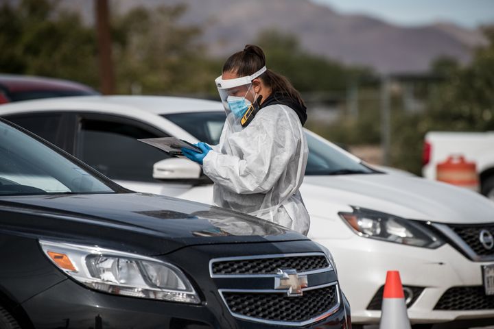 An attendant talks to a person waiting in their car at a coronavirus testing site in El Paso, Texas, on Oct. 31.