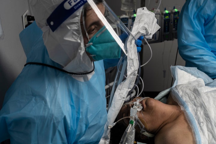 Medical staff members treat a patient suffering from COVID-19 in the COVID-19 intensive care unit at the United Memorial Medical Center in Houston on October 31.