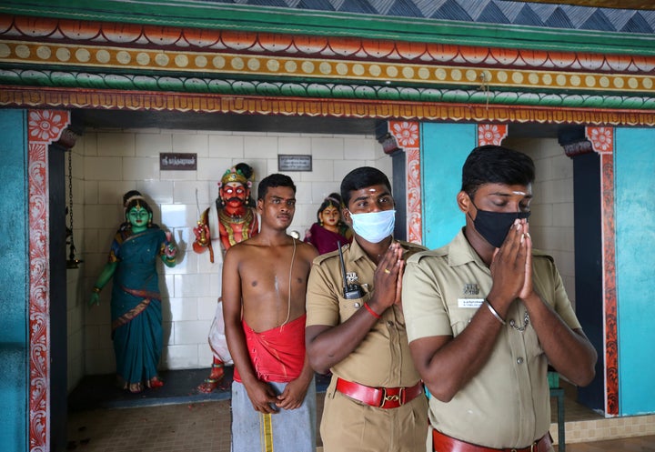 Policemen take part in a special prayer performed for the success of U.S. democratic vice presidential candidate Sen. Kamala Harris, at a temple in Thulasendrapuram, in Tamil Nadu state, India, on Nov. 3, 2020.