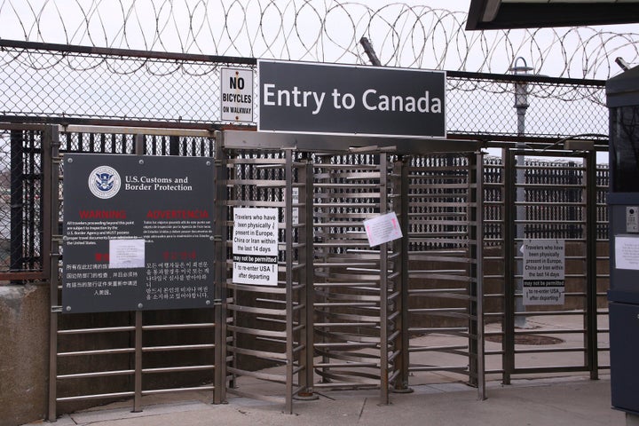 Signs hang on the entrance way to Canada via the Rainbow Bridge in Niagara Falls, N.Y. on March 18, 2020. 